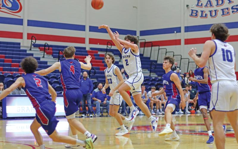 (THOMAS WALLNER | THE GRAHAM LEADER) Bryce Martin (2) jumps to make a shot as the time counts down to zero at the end of the quarter. Martin and the Steers attempted to close the scoring gap in the third and fourth quarters Friday, Jan. 3 against Abilene Cooper.