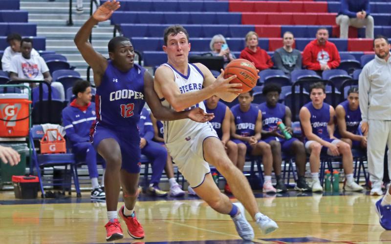 (THOMAS WALLNER | THE GRAHAM LEADER) Running past Abilene Cooper defenders, Ty Thompson looks to set up a shot Friday, Jan. 3.