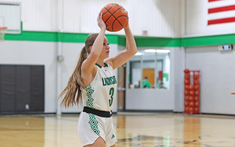 (THOMAS WALLNER | THE GRAHAM LEADER) Kenna Mahan looks for an open Ladycats player during the Friday, Jan. 3 matchup against Throckmorton. The district-opening game was a huge win for the team as it set sights on another championship win.