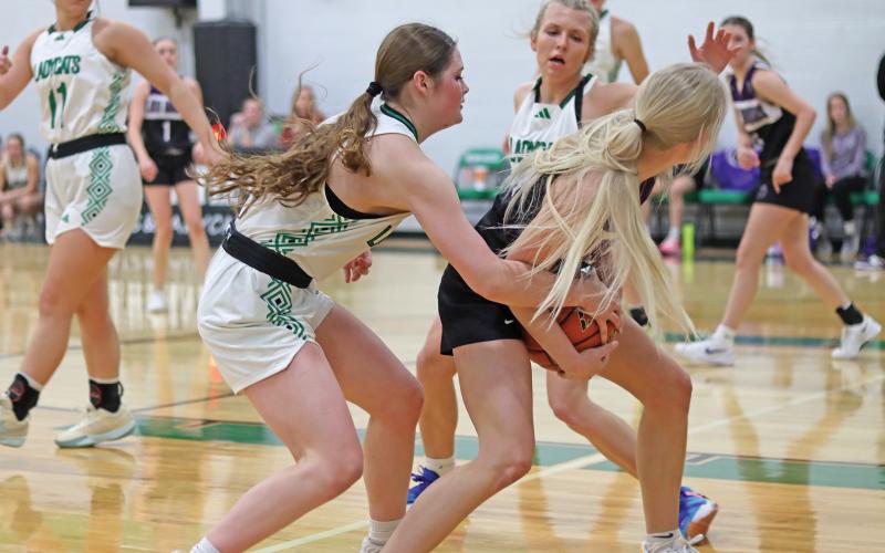 (THOMAS WALLNER | THE GRAHAM LEADER) Camren Mallory tries to steal possession of the ball during the Throckmorton district opener Friday, Jan. 3. Mallory had a total of six points in the game which ended with a big 59-28 win to open district play.