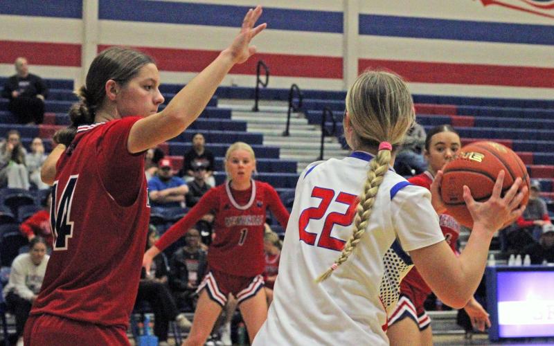(ALEX HAVARDANSKY | THE GRAHAM LEADER) Adi Pinkston looks to pass the ball Tuesday, Dec. 16 against the Memorial Lady Mavericks. The Lady Blues stayed composed despite adversity in their 52-41 victory over the Lady Mavericks. 