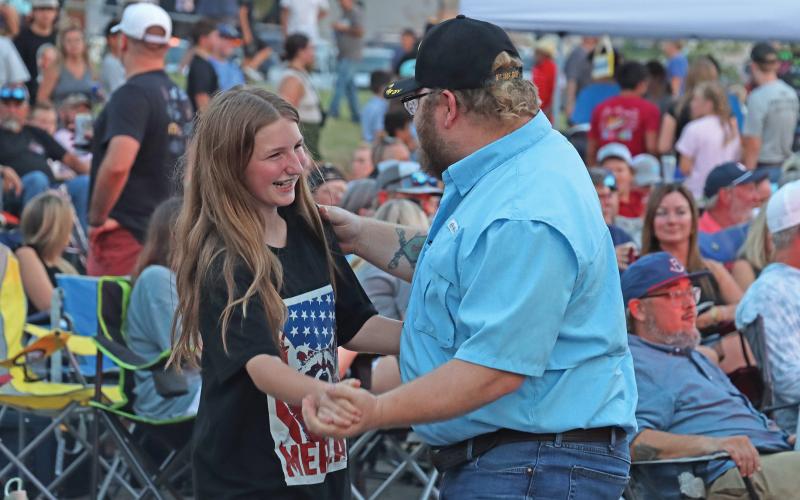 (ARCHIVE PHOTO | THE GRAHAM LEADER) Visitors to a the Graham Concert Series stand up and dance in front of the stage where Stoney LaRue was performing in August 2024. Five performers are scheduled for this summer series from June through August.