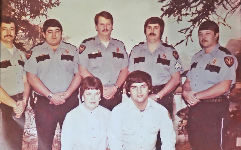 (CONTRIBUTED PHOTO | STEPHEN BRISTOW) The night crew of Graham Police Department in 1982 that worked from 11 p.m. to 7 a.m. each day. Shown from left to right are Stephen Bristow, David Uselton, Mark Dawson, Darrell Gilmore and Charlie Parker. Shown in front from left to right is Granny, the dispatcher and Tony Widner, who was serving as jailer.