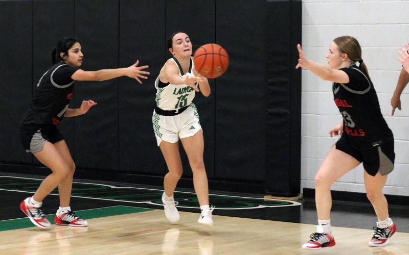 (ALEX HAVARDANSKY | THE GRAHAM LEADER)  Rae’Lynn Bennett passes the ball to a teammate Thursday, Dec. 18 against the Mineral Wells Lady Rams. The Newcastle Ladycats played a late-week matchup against the Archer City Lady Cats and made the hometown crowd happy, coming away with the victory by a final score of 43-30. 