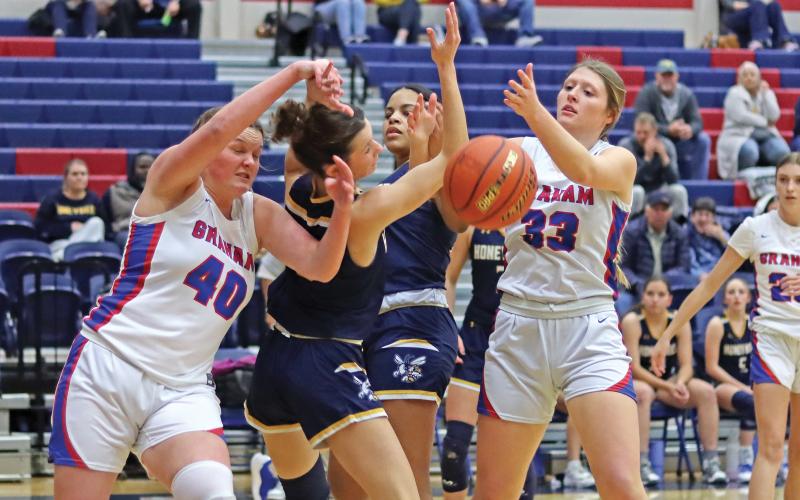 (THOMAS WALLNER | THE GRAHAM LEADER) Addyson Weaver (40) and Briley Randall (33) fight for possession of the ball from Stephenville during their Tuesday, Jan. 7 matchup. Randall and Weaver were a force for Lady Blues in the second quarter as the team pushed back on Stephenville.
