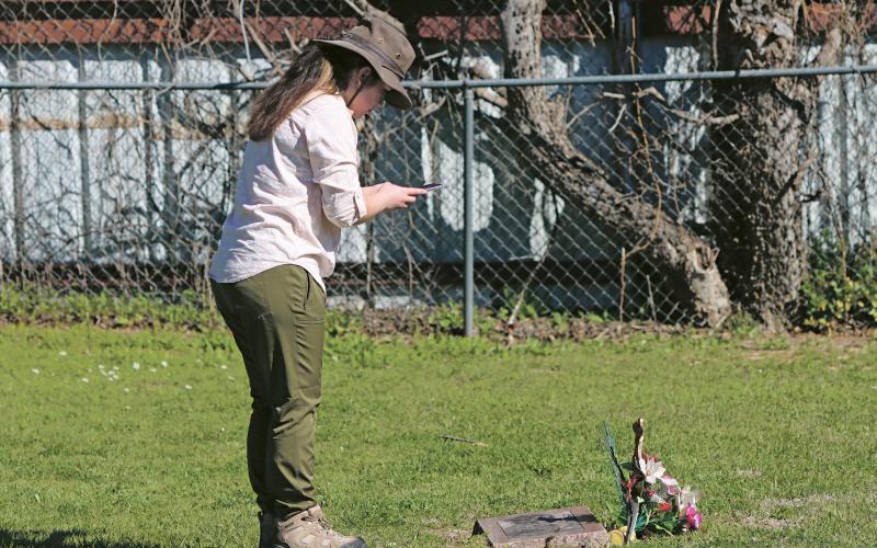 (KYLIE BAILEY | THE GRAHAM LEADER) Graduate student Alexia Calderon begins the 3D modeling of a current grave marker during day one of the Texas Tech University archaeological study at the Oak Grove Colored-William P. Johnston Memorial Cemetery.