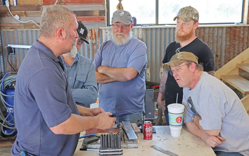 (THOMAS WALLNER | THE GRAHAM LEADER) Bill Poor teaches knife making Saturday, March 2 at the home of Greg Coker. Coker has worked to offer free knife-making instruction for veterans and first responders. 