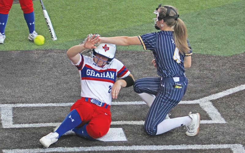 (ALEX HAVARDANSKY | THE GRAHAM LEADER) Ruby Shaffer slides into home after a wild pitch in the sixth inning Tuesday, March 19 against Stephenville. The Lady Blues opened district with a 5-4 at home.