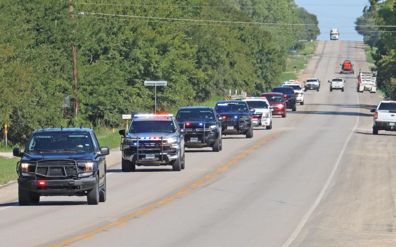 (THOMAS WALLNER | THE GRAHAM LEADER) Law enforcement officers escort retired K-9 Rocky to the Young County Sheriff’s Office to receive his final call before taking him to Faithful Companions Pet Crematory and Pet Cemetery of Strawn. Rocky served alongside his handler Devin Wright with YCSO.