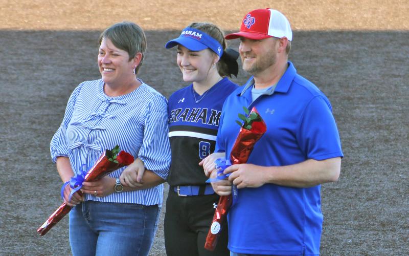 (ALEX HAVARDANSKY | THE GRAHAM LEADER) Zoey Harrell honored at senior night with her parents Tuesday, April 15. Harrell has been with the program for four years and has evolved into a veteran leader for the team. 
