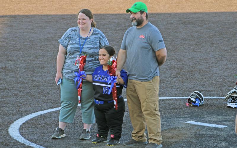 (ALEX HAVARDANSKY | THE GRAHAM LEADER) Katie Parker was honored with her parents alongside Harrell as an honorary team member Tuesday, April 15 for senior night. Parker is a senior at Graham High School and head coach Adam Arrington thought this would be an unforgettable experience.