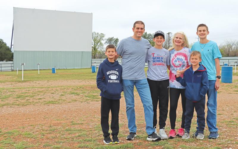(THOMAS WALLNER | THE GRAHAM LEADER) The McFerrins pose for a family photo in front of the Graham Drive In theater which they are taking over officially at the beginning of April. Shown from left to right are Cruz, Chip, Jett, Brandi, Cash and Mason McFerrin.