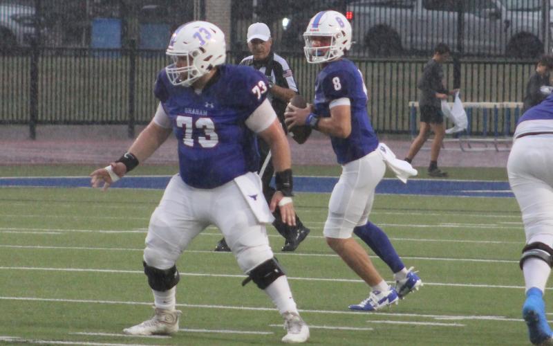 (ALEX HAVARDANKSY | THE GRAHAM LEADER) Jace Gill looks to pass from the pocket Friday, Sept. 5. Gill connected with Brodie Martin on big passes to end the half on a scoring drive.