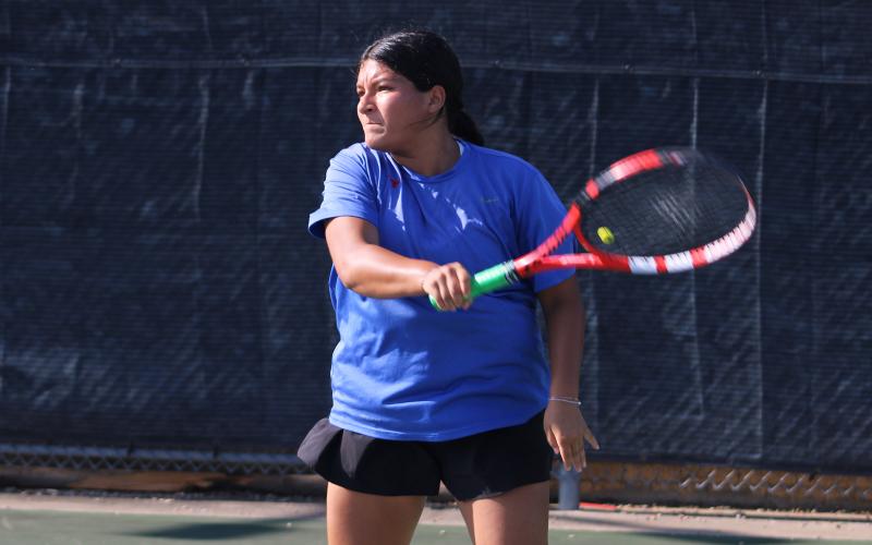 (ALEX HAVARDANKSY | THE GRAHAM LEADER) Jade Dospapas returns a ball in a singles match. Dospapas was one of two players to record a win against Iowa Park with an 8-2 singles victory. 