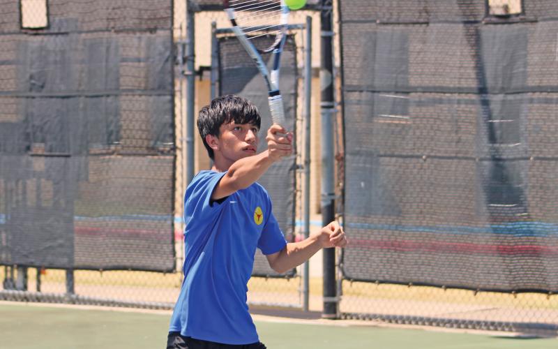 (ALEX HAVARDANSKY | THE GRAHAM LEADER) Jordan Miranda goes for an overhead serve return Wednesday, Aug. 6. Miranda won his singles match in a hard fought bout 8-5 over his Azle opponent.