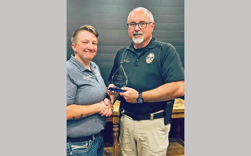 (OPD | CONTRIBUTED PHOTO) Olney Police Department Chief Dan Birbeck presents the first K-9 Corporal Miranda Wright Memorial Award to Graham Police Department Sgt. Hailey Calcote during the 2025 United States Police Canine Association, Inc. Annual K-9 Trials Awards Ceremony held Saturday, May 3.