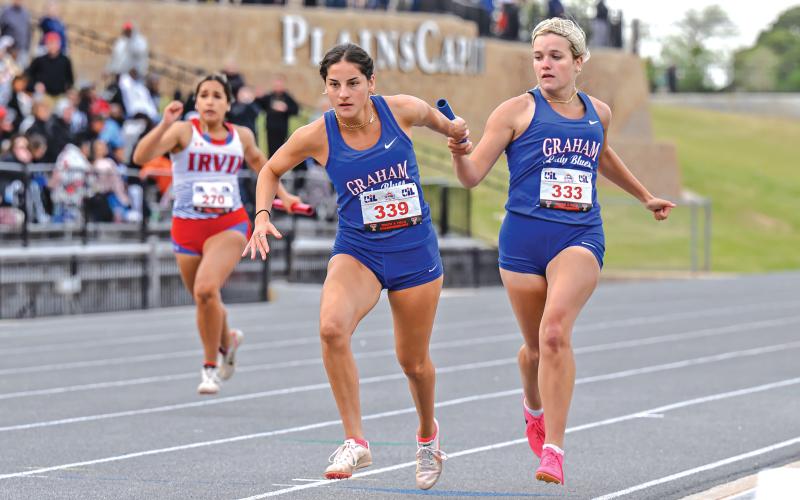 (DAVID FLYNN | CONTRIBUTED PHOTO) Kaden Atwood (right) passes the baton to teammate Georgia Martin (left) during one of the relay races at the regional meet in Lubbock. The Lady Blues’ relay teams finished sixth in the preliminaries in each of their races.