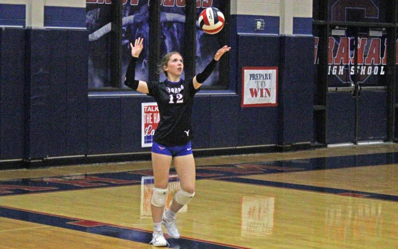 (ALEX HAVARDANSKY | THE GRAHAM LEADER) Kate Hufstedler throws the ball up in the air for a serve Tuesday, Sept. 23, against the Brownwood Lady Lions. The Lady Blues three-set win prepped the crowd for a fun senior night.