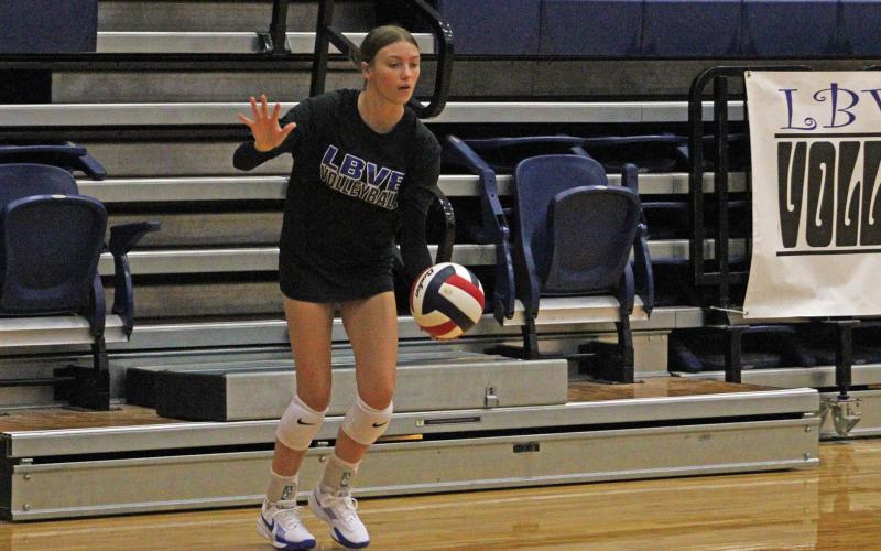 (ALEX HAVARDANSKY | THE GRAHAM LEADER) Katy McGehee prepares to throw the ball up for a serve Saturday, Aug. 9. The Lady Blues participated in scrimmages over the weekend to prepare for the regular season.
