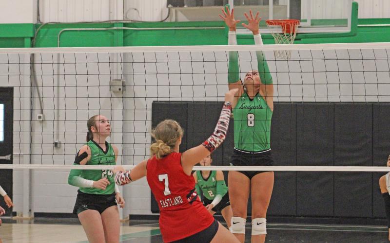 (ALEX HAVARDANSKY | THE GRAHAM LEADER) Kenzie King jumps up at the front of the net for a block attempt in one of the Ladycats matches. King had eight kills offensively in the Ladycats three set win over Bryson. 