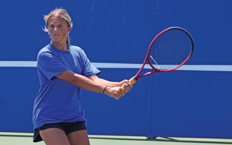 (ALEX HAVARDANSKY | THE GRAHAM LEADER) Kline Krupp lines up to take a swing at a ball Wednesday, Aug. 6. The doubles team of Jade Dospapas and Krupp got the lone win for the Lady Blues doubles team against Azle.