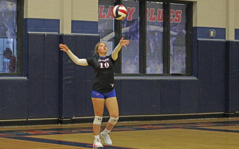 (ALEX HAVARDANSKY | THE GRAHAM LEADER) Kylie Pruitt throws the ball up for a serve Tuesday, Aug. 19. One of the strengths for the team was staying in games at the service line.