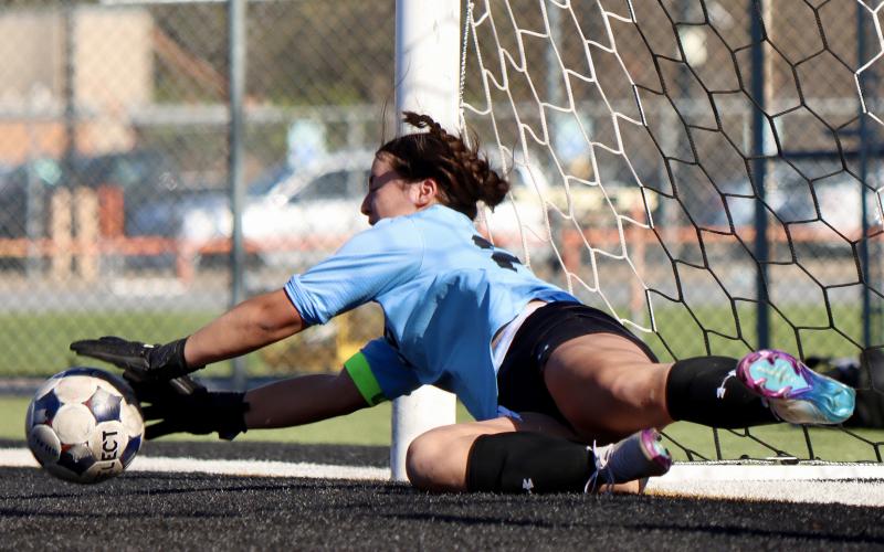 (THOMAS WALLNER | THE GRAHAM LEADER) Lady Blues goalie Taylor Lauster blocks a shot from a Canyon Randall Lady Raiders player during a penalty shootout. The Lady Blues won 3-0 in the first round of the shootout during the bi-district matchup Thursday, March 19.