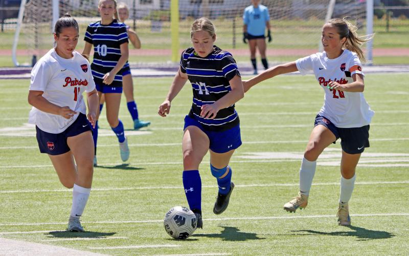 (THOMAS WALLNER | THE GRAHAM LEADER) Adi Pinkston runs the ball away from the Lady Blues’ side of the field during the area playoffs held Tuesday, March 24. The team came away with a historic 1-0 win over the Lubbock-Cooper Liberty Lady Patriots.