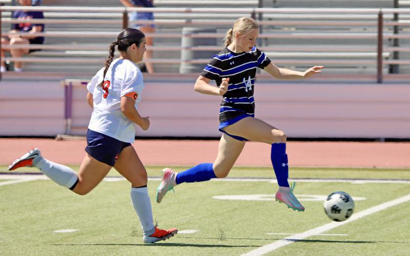 (THOMAS WALLNER | THE GRAHAM LEADER) Ella Pettus moves down the field to attempt a shot at the goal during the area matchup Tuesday, March 24 against the Lubbock-Cooper Liberty Lady Patriots at Sandifer Stadium in Abilene.