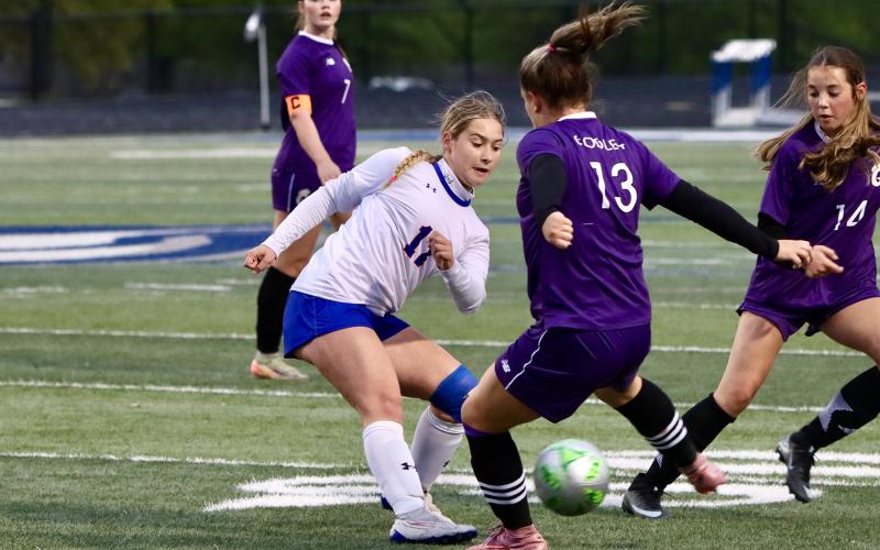 (THOMAS WALLNER | THE GRAHAM LEADER) Lady Blue Adi Pinkston kicks a ball through the legs of an opposing player with the Godley Ladycats during the regional semifinal game held Friday, March 27 in Weatherford.