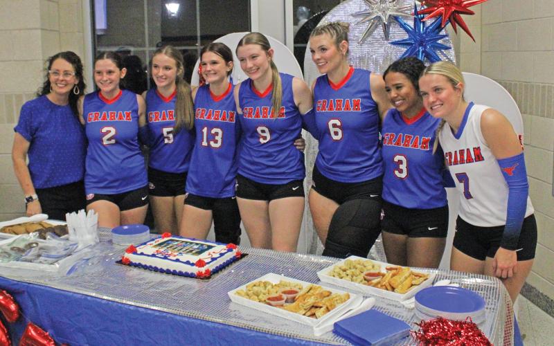 (ALEX HARVADANSKY | THE GRAHAM LEADER) The Lady Blues senior players were honored Tuesday, Sept. 23. Shown from left to right are head coach Marci Faulk and senior players Madison Cauble, Kathryn Hughes, Tara Dawson, Rylee Moore, Treyton McCullough, Izzy Alejo and Kaden Atwood. 