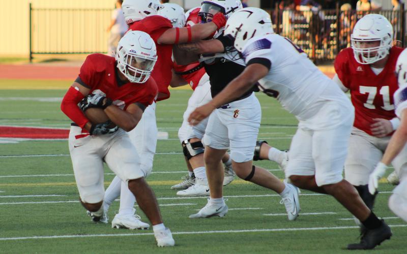 (ALEX HAVARDANKSY | THE GRAHAM LEADER) Mike Garcia runs up the middle Thursday, Aug. 21, against Godley. Garcia came over from playing baseball and has made a strong impression on the team.