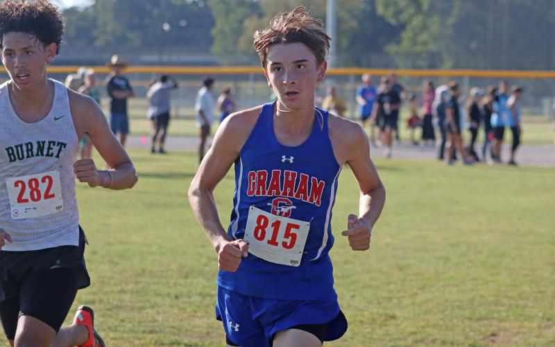 (KYLIE BAILEY | THE GRAHAM LEADER) Nolan Wankowicz runs around the course at the Thrill of the Hill Invitational which took place Wednesday, Oct. 1, in Stephenville. Wankowicz was the top boys runner finishing 58 out of 166 runners.