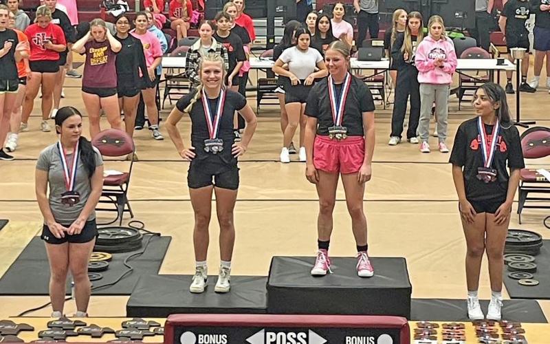 (NEWCASTLE ISD | CONTRIBUTED PHOTO) Catherine Youngblood (left) shows off her second place medal she received in the 114-pound weight class which advanced her to the state powerlifting competition. The Ladycats team participated in the regional powerlifting meet Saturday, March 1.