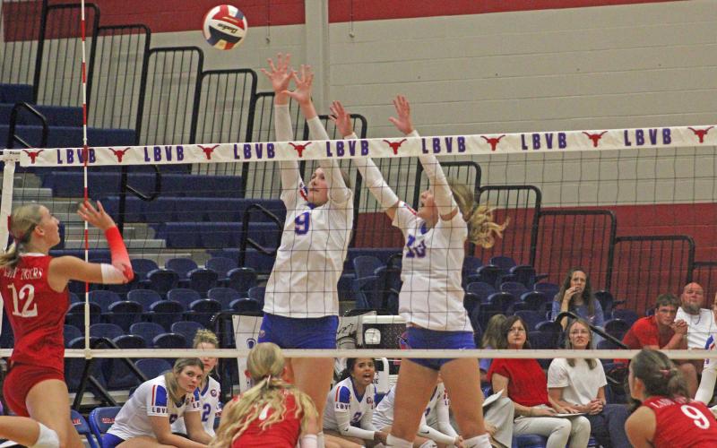 (ALEX HAVARDANSKY | THE GRAHAM LEADER) Rylee Moore, 9, and Emily Hughes, 10, go up for a block Friday, Sept. 26, against Glen Rose. Moore and Hughes combined for four blocks and 10 kills on the night.