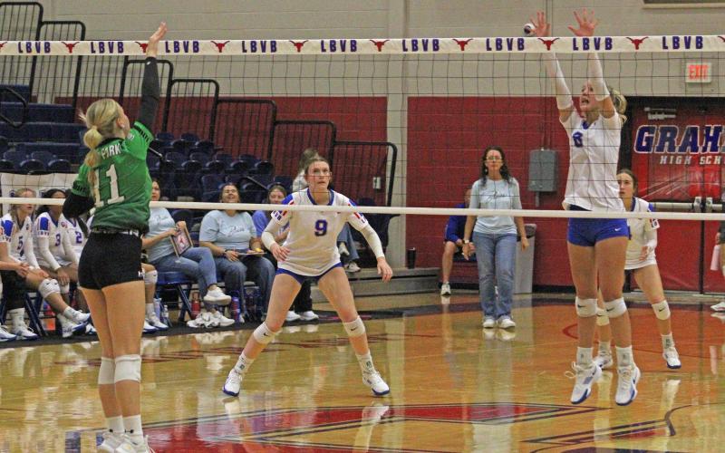 (ALEX HAVARDANKSY | THE GRAHAM LEADER) Kya Cooper goes up for a block while Rylee Moore covers her Friday, Sept. 5. Cooper had 19 assists during the teams match against Iowa Park while Moore had five kills and three blocks.