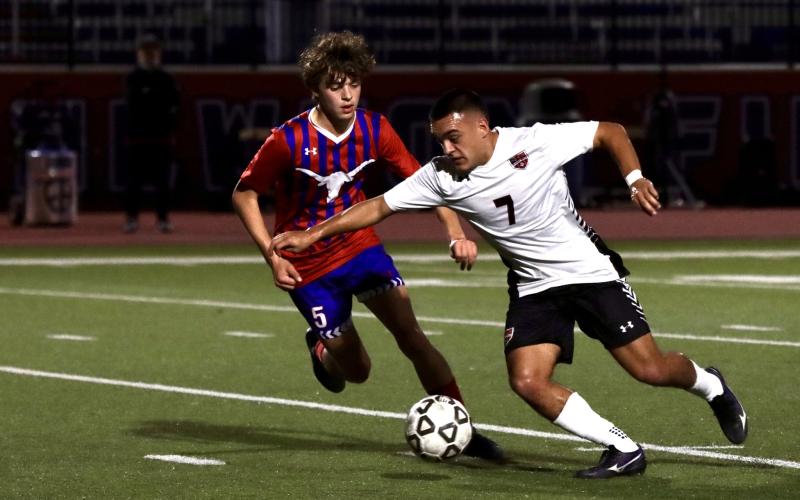 (KYLIE BAILEY | THE GRAHAM LEADER) Hudson Weatherman chases down a ball Friday, Feb. 13 against the Mineral Wells Rams. The Steers lost 3-0 to the Rams in the contest. 