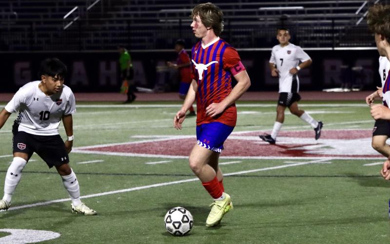 (KYLIE BAILEY | THE GRAHAM LEADER) Jace Gill pushes the offense up the field Friday, Feb. 13 against the Mineral Wells Rams. Gill was one of the graduating seniors honored on senior night. 