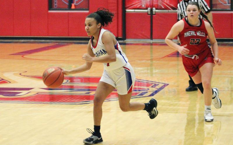 (TC GORDON | THE GRAHAM LEADER) Savannah Fricks brings the ball up the court as the Lady Blues’ offense gets set to run a play. The JV Red Lady Blues beat the Mineral Wells JV Lady Rams 31-16 last Friday, Jan. 19.