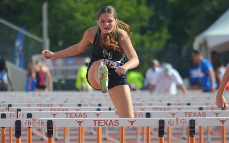 (COLTON MCWILLIAMS | CONTRIBUTED PHOTO) Newcastle’s Camren Mallory jumps over the final hurdle in the 100-meter hurdles race Saturday, May 16 in the UIL Track & Field State Meet. Mallory came away with a seventh-place finish at the meet.
