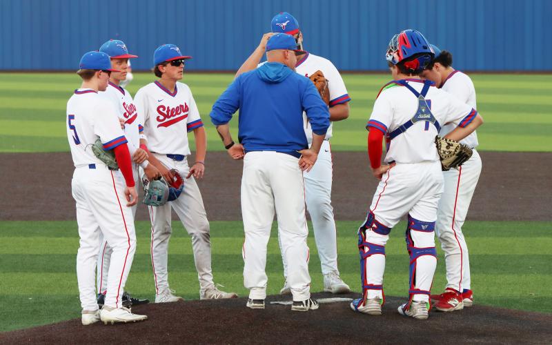(THOMAS WALLNER | THE GRAHAM LEADER) Steers head coach Allen McGee speaks to his team during the Steers’ 10-0 home loss Tuesday, March 24.