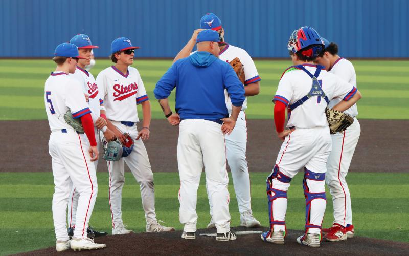 (THOMAS WALLNER | THE GRAHAM LEADER) Steers head coach Allen McGee speaks to his team during the Steers home game Tuesday, March 24. The team was swept by the Mineral Wells Rams in a two-game series April 9-10.