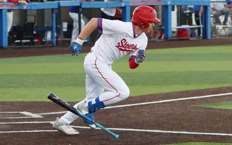 (THOMAS WALLNER | THE GRAHAM LEADER) Cooper Corley makes a mad dash to first base during the Steers district opener against the Brock Eagles at home Tuesday, March 24. 