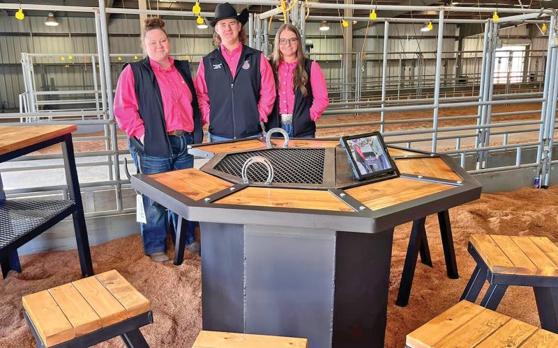 (GRAHAM FFA | CONTRIBUTED PHOTO) A team made up of Allie Posey, Kanyon Crawford and Kiya Cope which won first place in their division for Ag Mechanics at the San Angelo Stock Show & Rodeo. Shown is their project which was an octagonal table with a firepit and grill in the center.