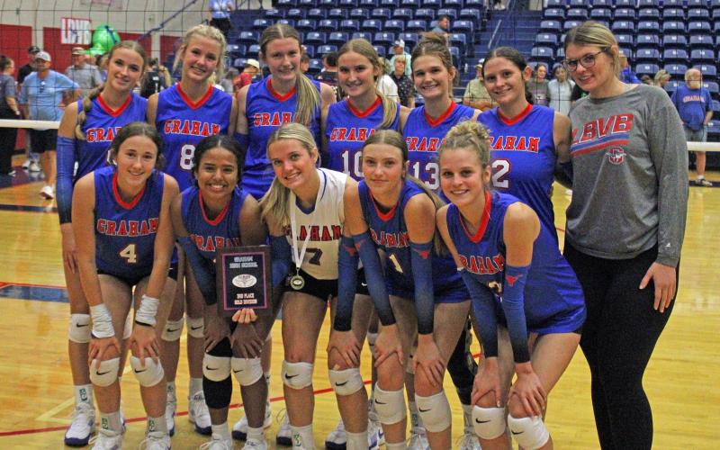 (ALEX HAVARDANSKY | THE GRAHAM LEADER) The Lady Blues pose for a photo Saturday, Aug. 23, after the Lu Allen Memorial Volleyball Tournament. The team took home third place while Kaden Atwood was nominated to the all tournament team.