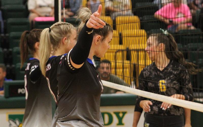 (ALEX HAVARDANSKY | THE GRAHAM LEADER) Treyton McCullough, front, sets up defensively in the front row for the Lady Blues in their matchup Tuesday, Aug. 26. McCullough returned to the court on this date while also picking up her first point on the season.