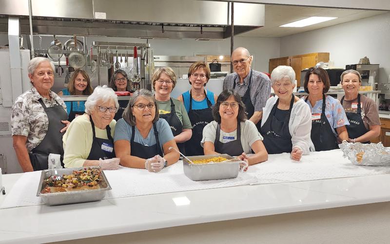 (BRONWEN CHOATE | CONTRIBUTED PHOTO) Volunteers take a group shot before serving at the Our Daily Bread program in 2024 at First United Methodist Church in Graham. This year’s program will begin Monday, July 7 at the FUMC McCree Hall.