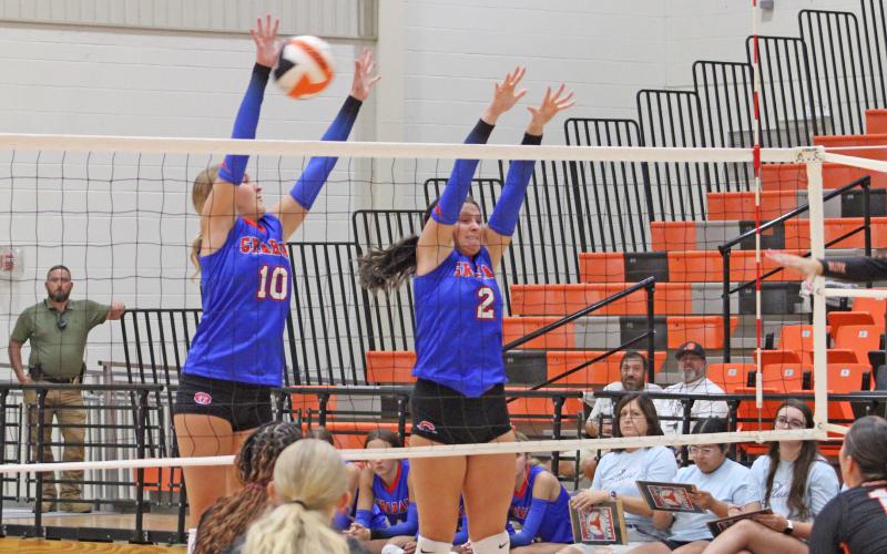 (ALEX HAVARDANSKY | THE GRAHAM LEADER) Emily Hughes (left) and Madison Cauble (right) go up for a block Tuesday, Aug. 12, against the Lady Bulldogs. Cauble had a set clinching block to seal a set three win for the team.