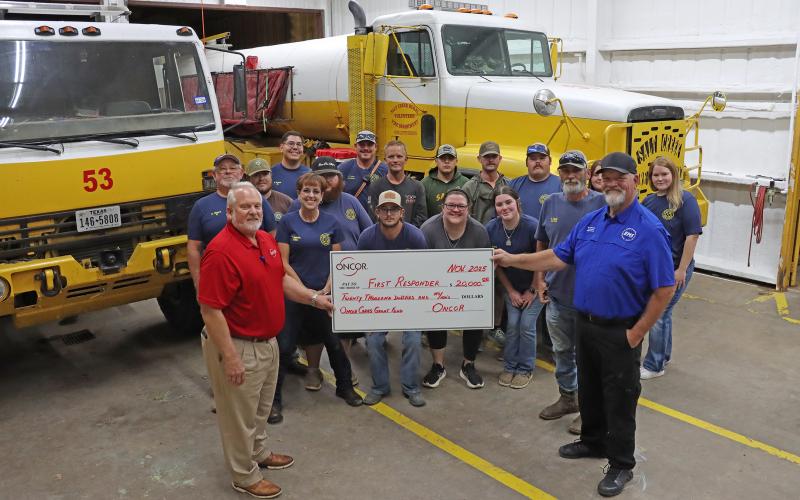 (THOMAS WALLNER | THE GRAHAM LEADER) Members of Salt Creek Volunteer Fire Department are presented a $20,000 check by Oncor Area Manager Gordon Drake as part of an investment in volunteer departments from the Oncor Cares Foundation. The department is one of 26 that will be presented with checks from the foundation.