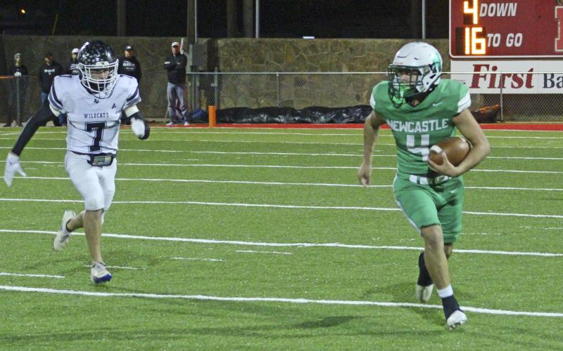 (ALEX HAVARDANKSY | THE GRAHAM LEADER) Rylan Hinojosa carries the ball to the sideline Friday, Nov. 21 in the Bobcats’ area round playoff matchup. Hinojosa was named a first team all district quarterback for the Bobcats as well as a first team all district defensive lineman. 